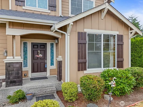 a view of a house with door and a yard