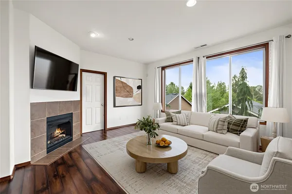 a living room with furniture a fireplace and a flat screen tv