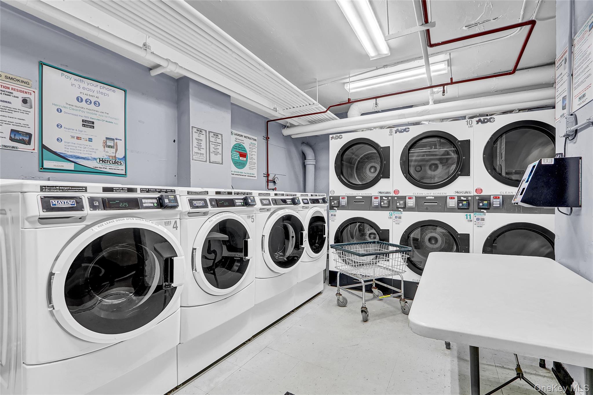 123-40 83rd Avenue, Unit 6D Queens, NY 11415 - Photo 14 of 14 Shared laundry room featuring washing machine and clothes dryer and stacked washer / drying machine