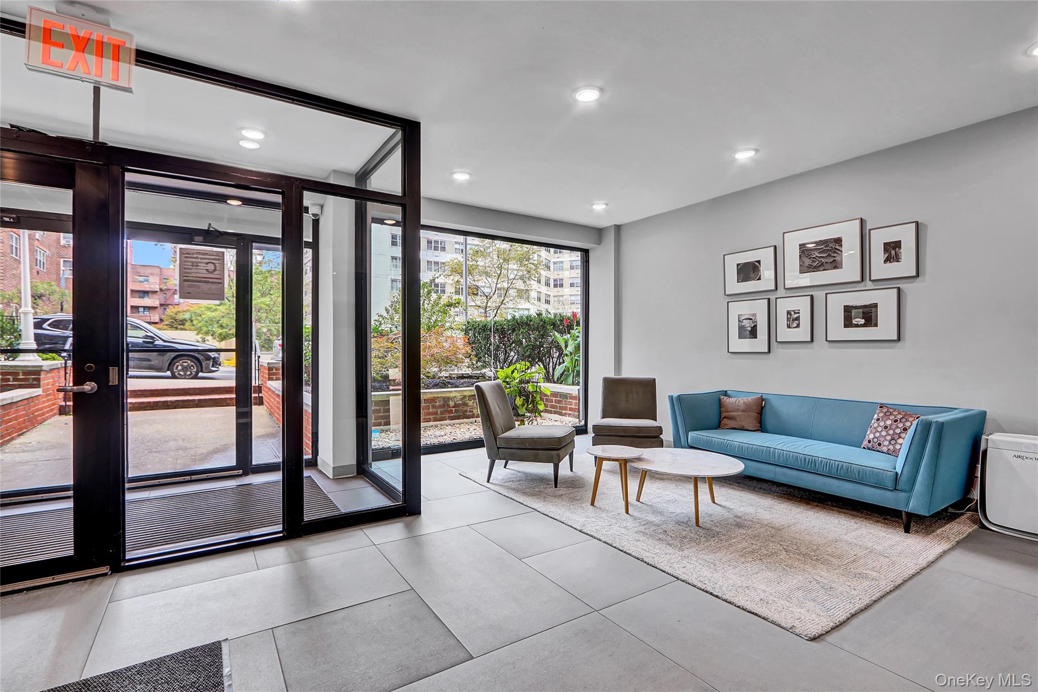 123-40 83rd Avenue, Unit 6D Queens, NY 11415 - Photo 3 of 14 Lobby with a wall of windows and recessed lighting