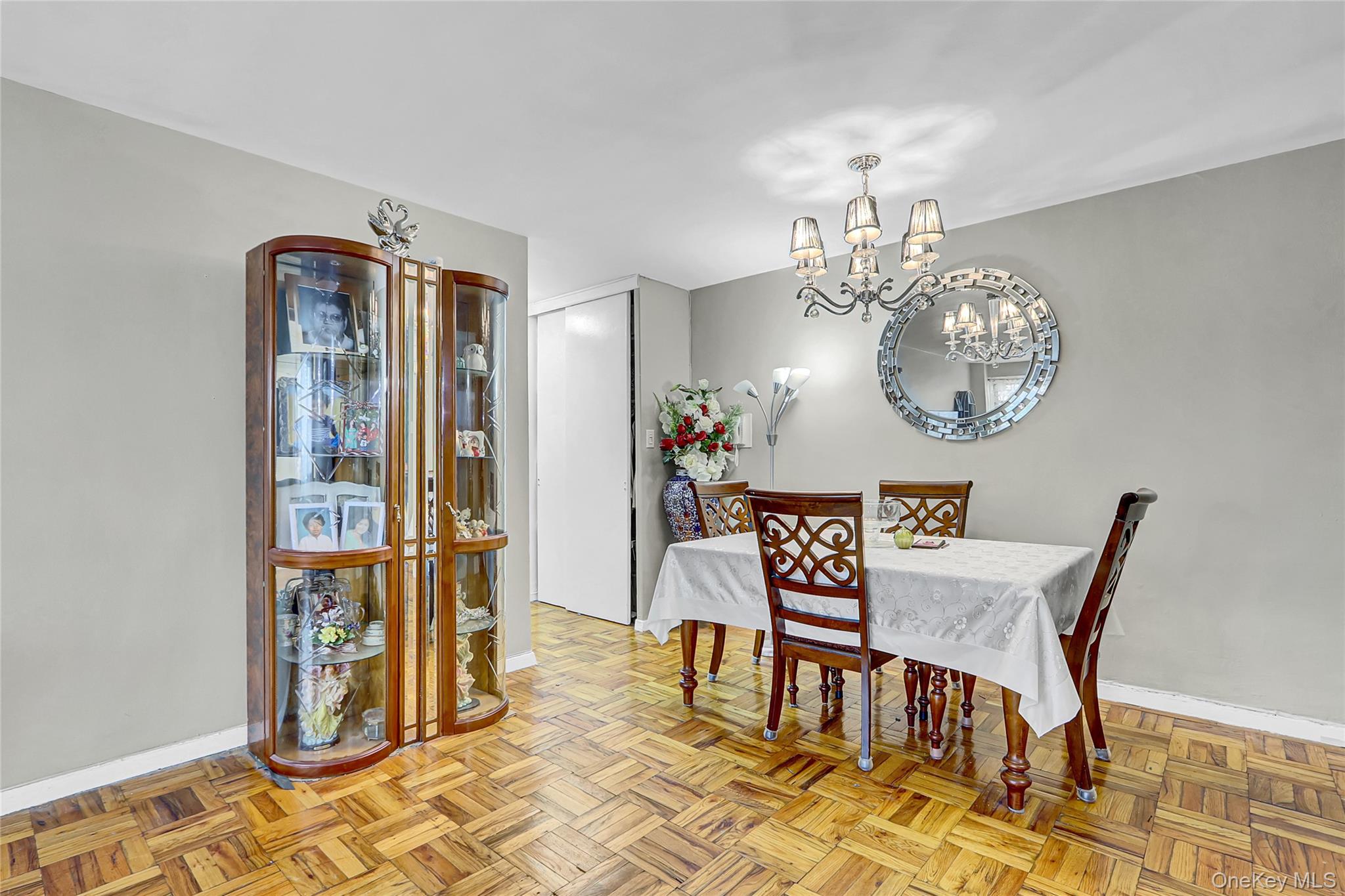 123-40 83rd Avenue, Unit 6D Queens, NY 11415 - Photo 8 of 14 Dining space featuring baseboards and a chandelier
