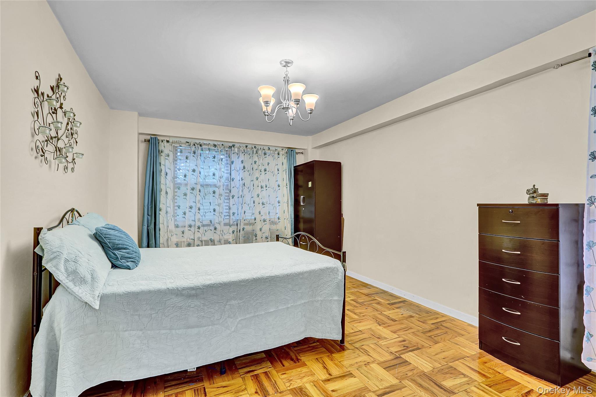 123-40 83rd Avenue, Unit 6D Queens, NY 11415 - Photo 10 of 14 Bedroom featuring baseboards and a chandelier