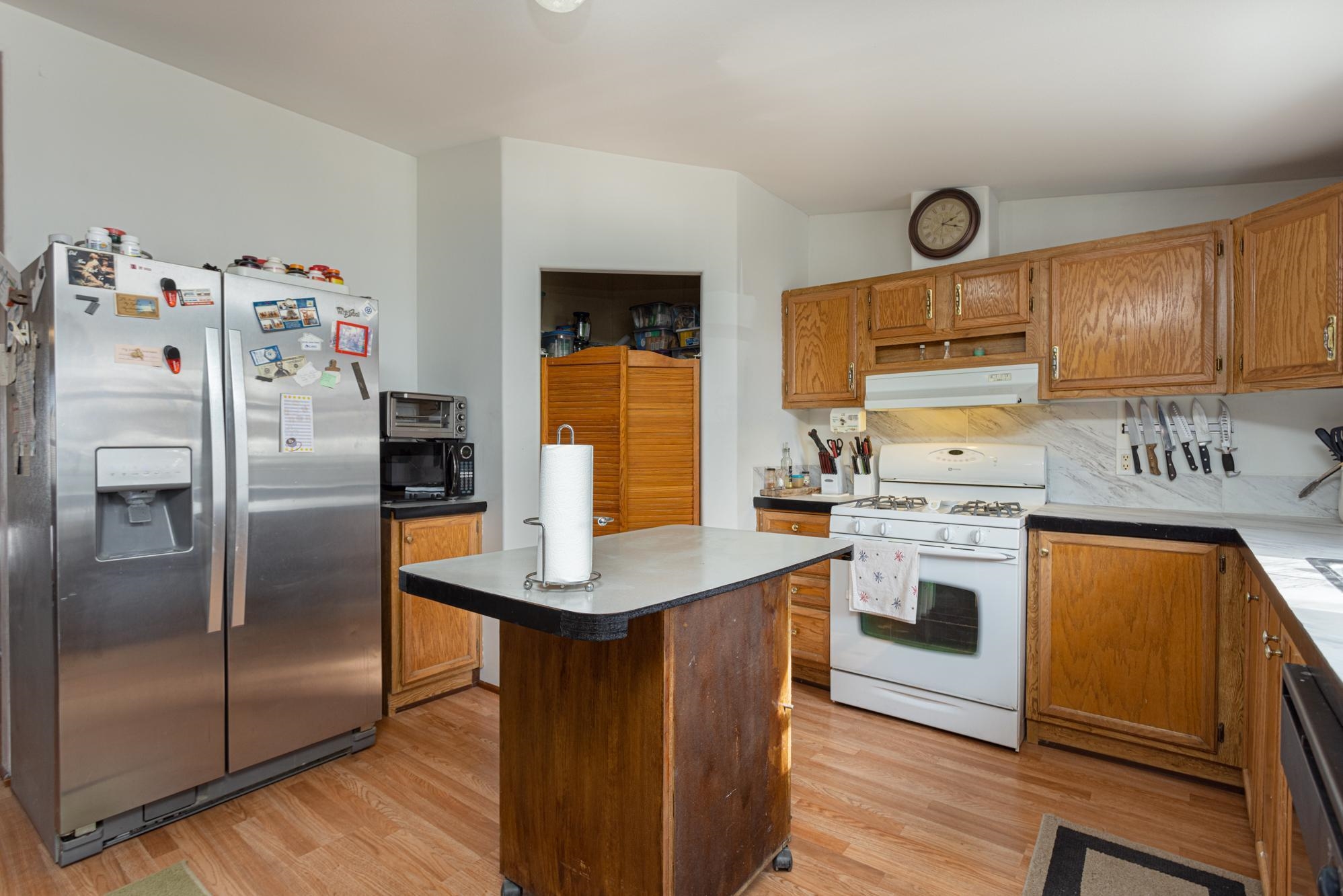 1546 10 Road Mack, CO 81525 - Photo 4 of 34 a kitchen with stainless steel appliances a refrigerator a stove a sink and cabinets