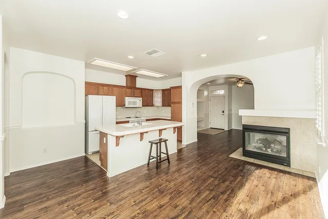 a kitchen with stainless steel appliances a stove top oven and a refrigerator