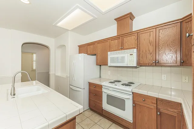 a kitchen with stainless steel appliances a refrigerator sink and cabinets
