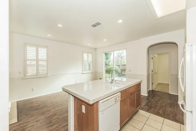 a living room with a sink and dishwasher
