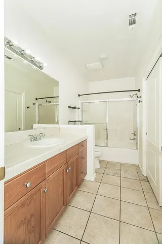 a large bathroom with a sink a mirror and a shower