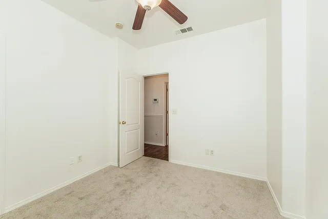 a view of a room with a ceiling fan