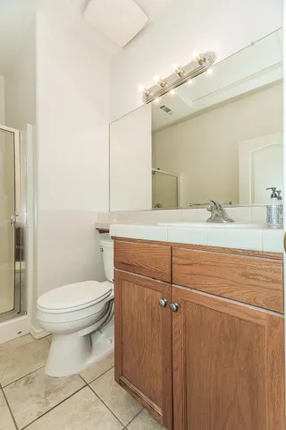 a bathroom with a sink a toilet and mirror