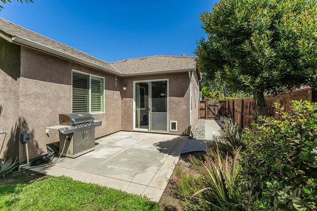 a view of a house with backyard and sitting area