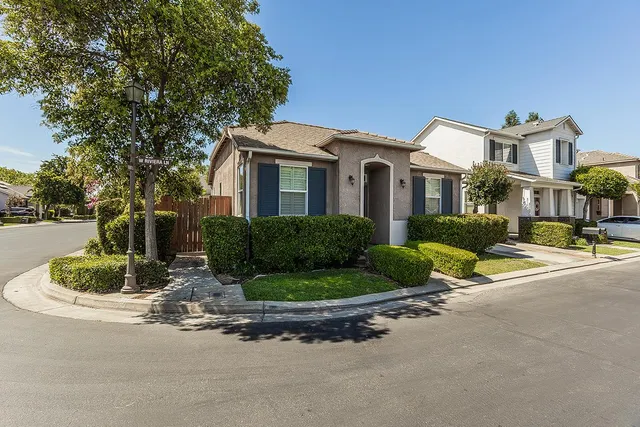 a front view of a house with a yard and outdoor seating
