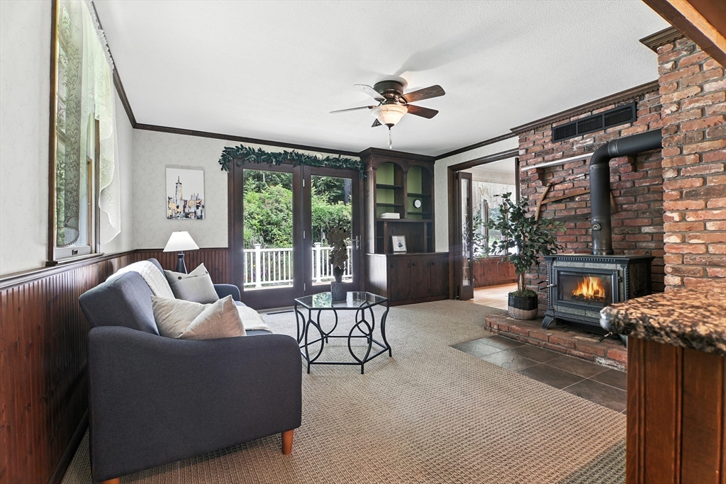 134 Chester Road Blandford, MA 01008 - Photo 8 of 41 a living room with furniture a fireplace and a large window
