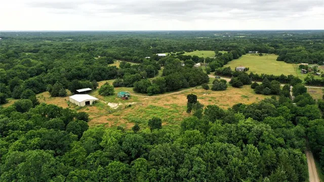 a view of a swimming pool with lawn chairs and a potted plant