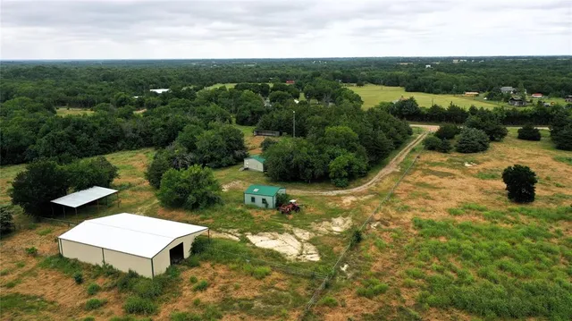 an aerial view of a house with a yard