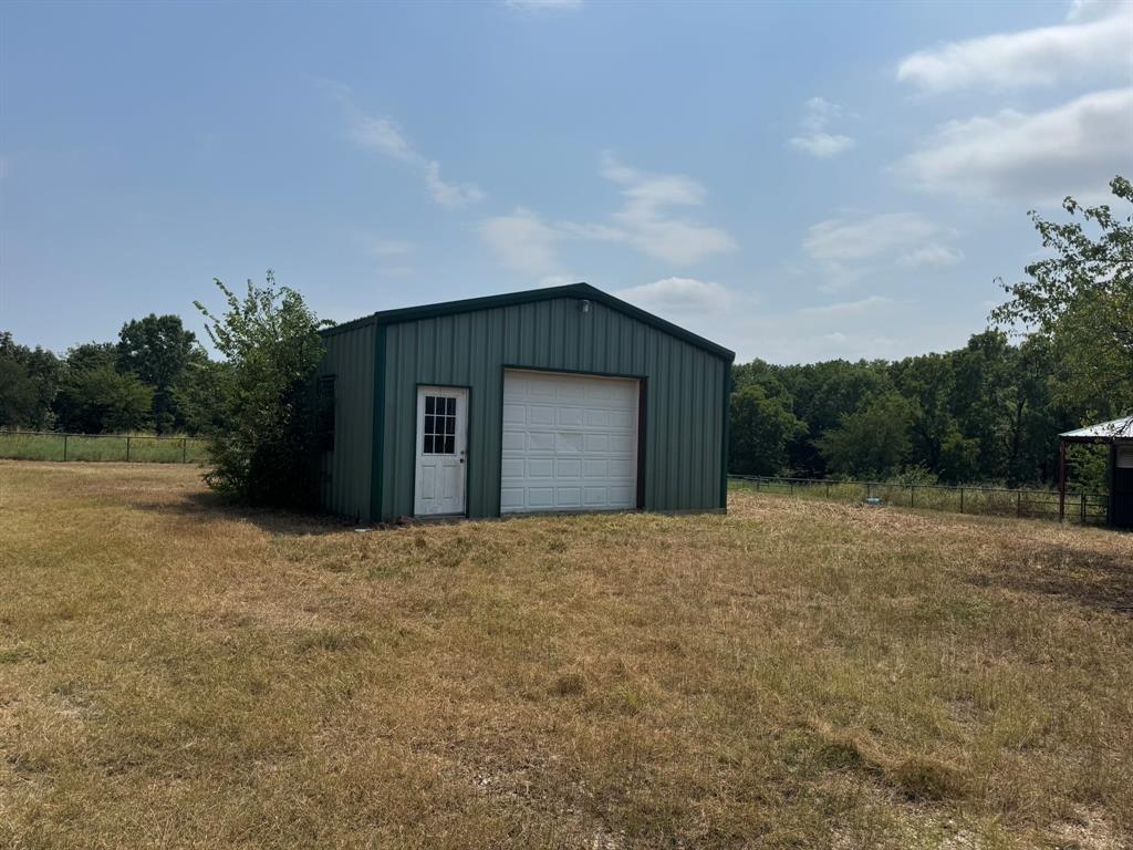 1980 County Road 3040 Bonham, TX 75418 - Photo 3 of 34 a house with trees in front of it
