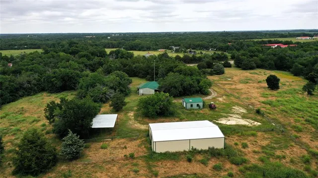 an aerial view of a house with yard