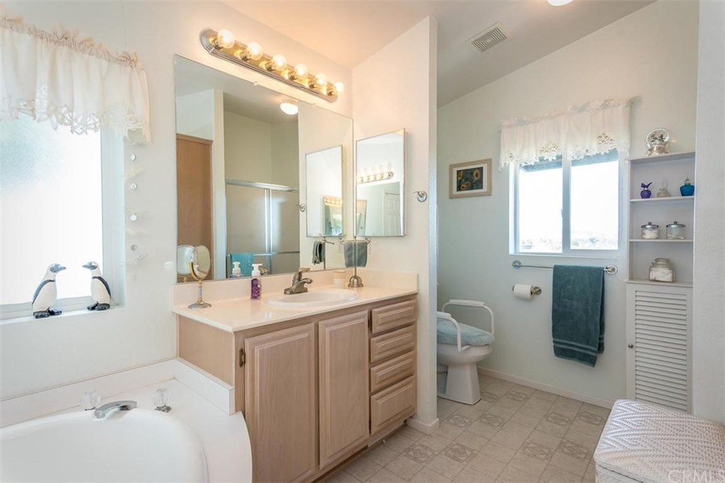 352 Quail Summit Paso Robles, CA 93446 - Photo 18 of 33 a bathroom with a double vanity sink toilet and a mirror