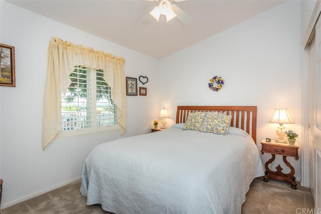 352 Quail Summit Paso Robles, CA 93446 - Photo 19 of 33 a bedroom with a large bed and a chandelier