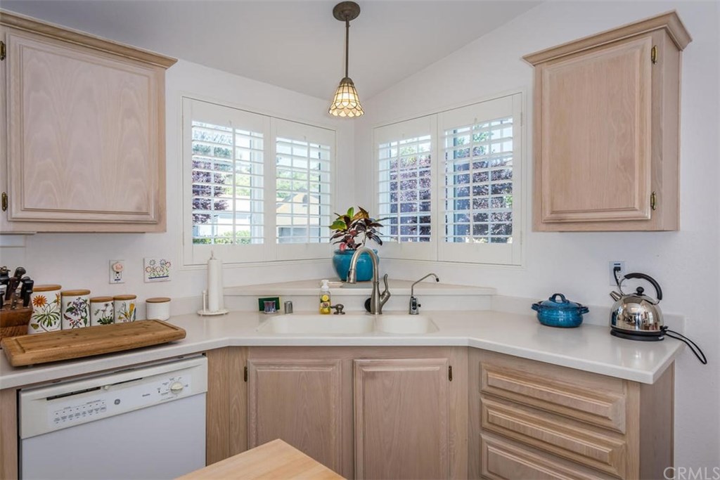 352 Quail Summit Paso Robles, CA 93446 - Photo 10 of 33 a kitchen with stainless steel appliances white cabinets a potted plant a sink and a window