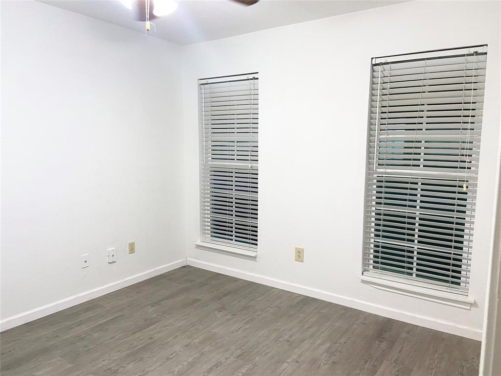 2121 Stone Moss Lane Grapevine, TX 76051 - Photo 12 of 17 a view of an empty room with wooden floor and a window