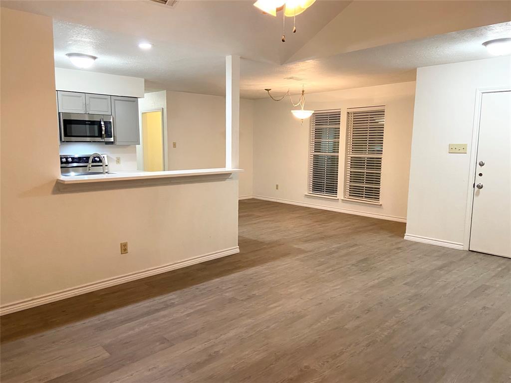 2121 Stone Moss Lane Grapevine, TX 76051 - Photo 4 of 17 a view of kitchen with wooden floor and window