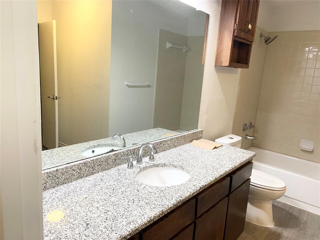 2121 Stone Moss Lane Grapevine, TX 76051 - Photo 9 of 17 a bathroom with a granite countertop sink and a mirror