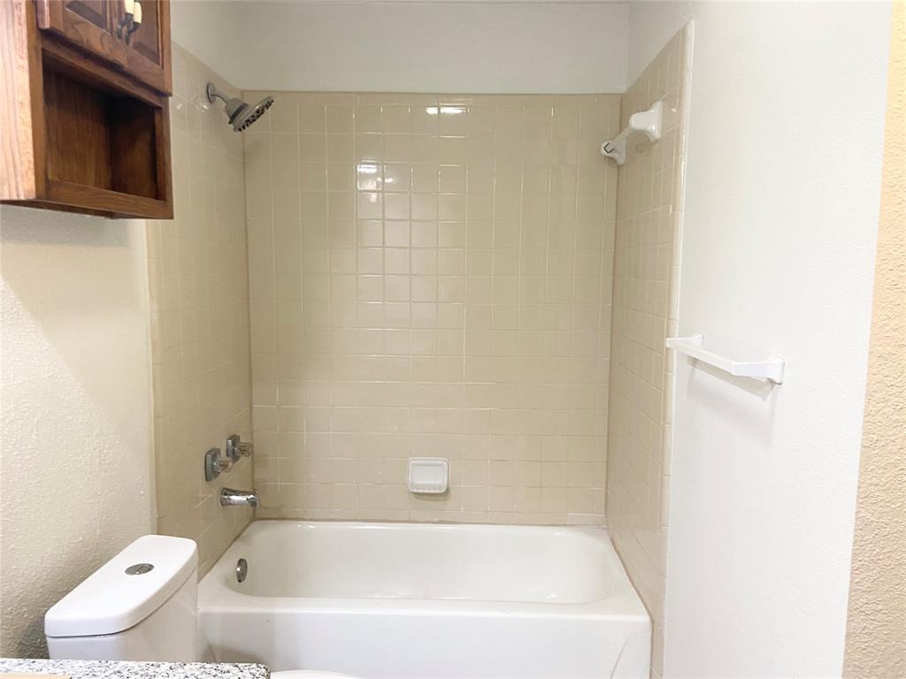 2121 Stone Moss Lane Grapevine, TX 76051 - Photo 10 of 17 a white bath tub sitting next to a toilet