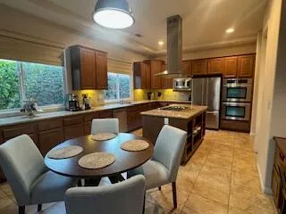a kitchen with stainless steel appliances kitchen island granite countertop a sink and cabinets