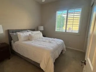 a bedroom with a bed and a window