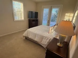 a bedroom with a bed and a tv