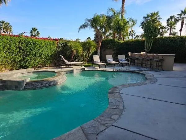 a view of a swimming pool with a patio