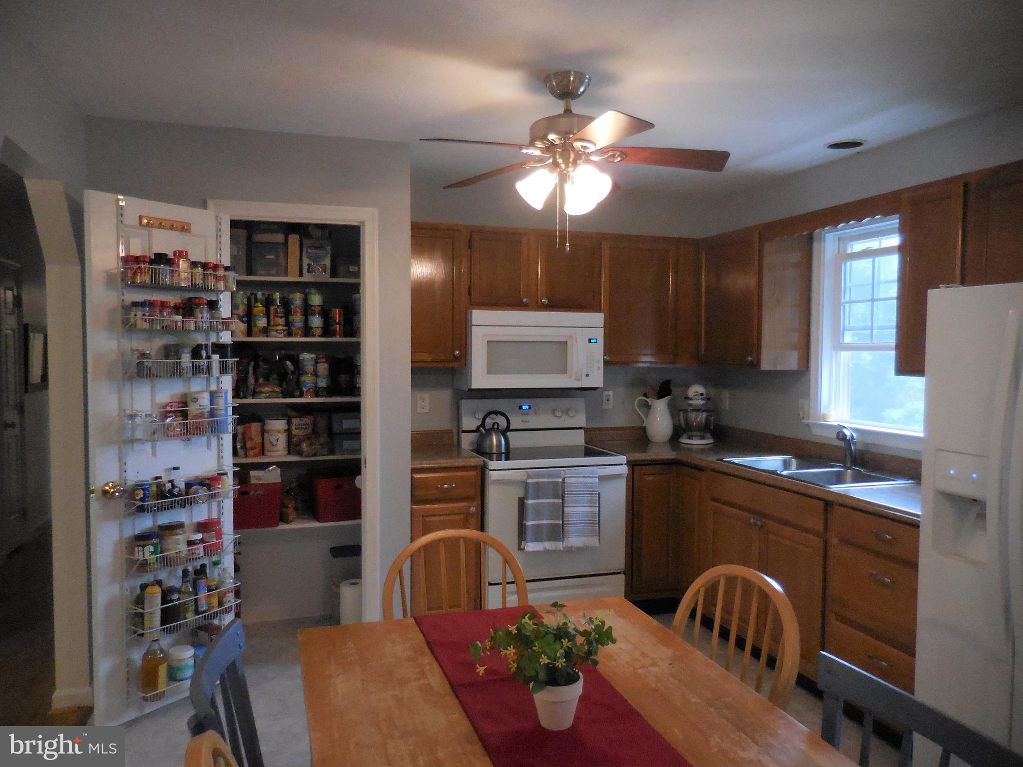 140 Arrowood Road Linden, VA 22642 - Photo 15 of 49 a kitchen with stainless steel appliances granite countertop a stove top oven a sink dishwasher and cabinets with wooden floor