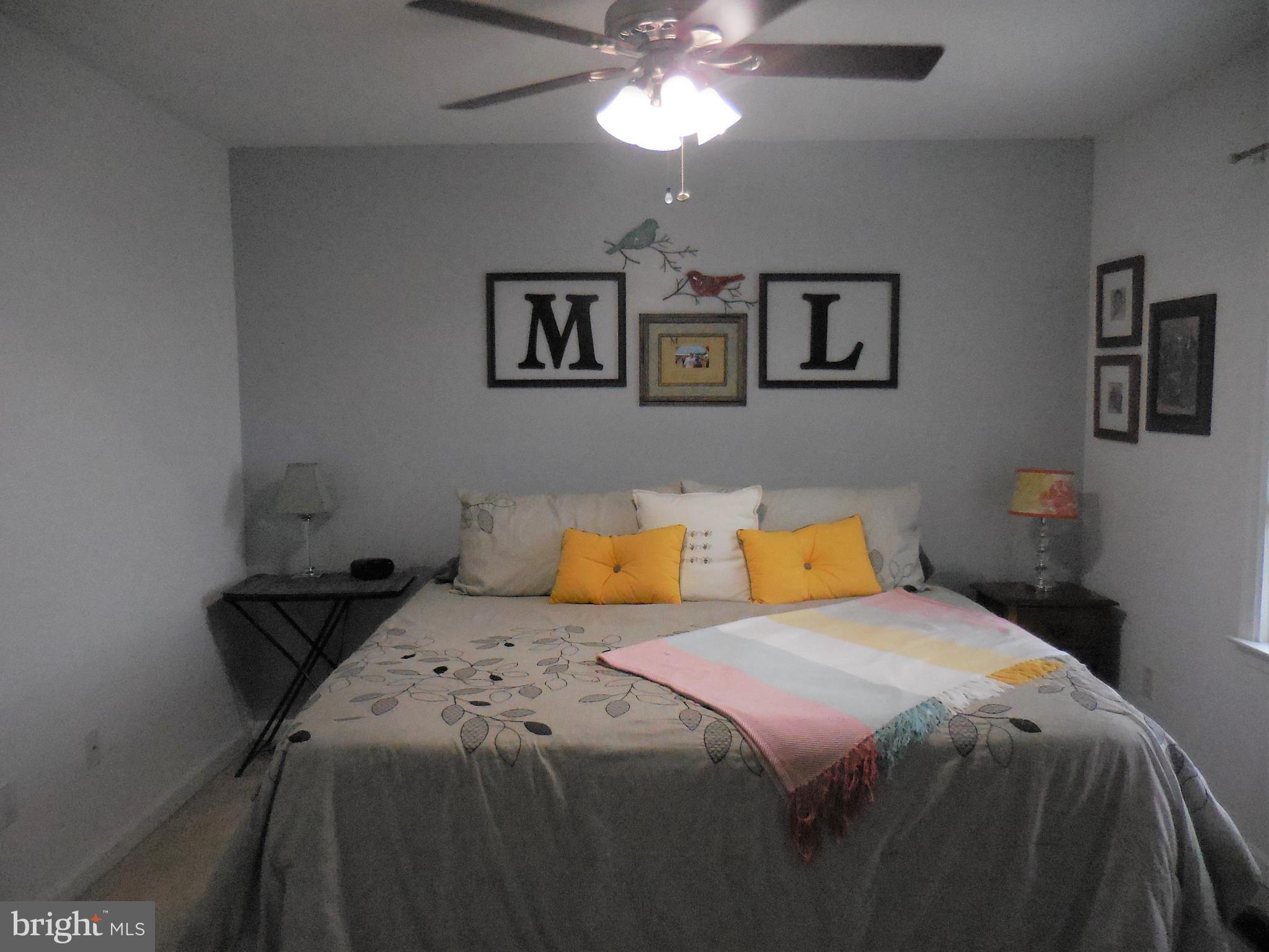 140 Arrowood Road Linden, VA 22642 - Photo 21 of 49 a bedroom with a bed and a chandelier