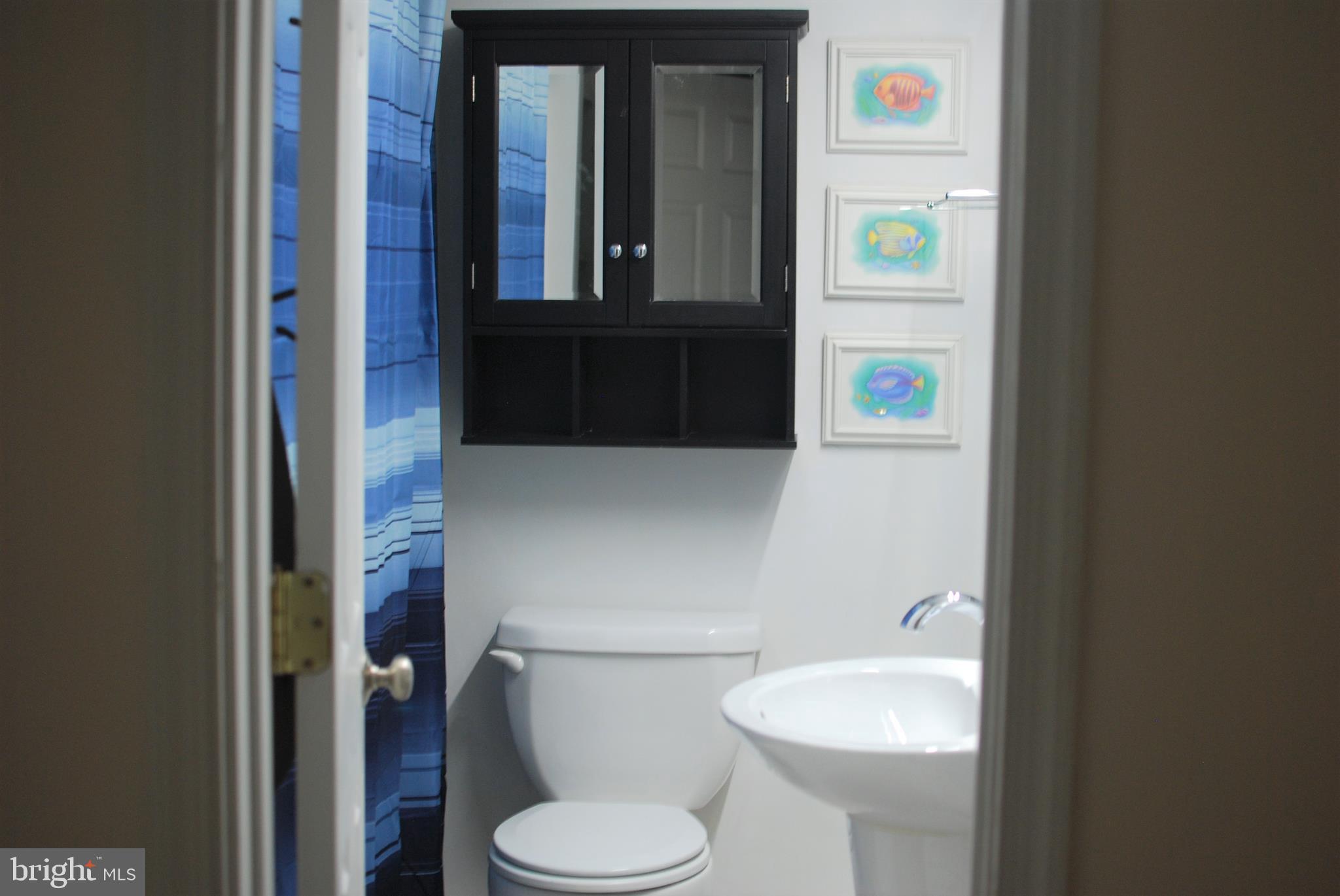 140 Arrowood Road Linden, VA 22642 - Photo 31 of 49 a white toilet sitting next to a bathroom sink