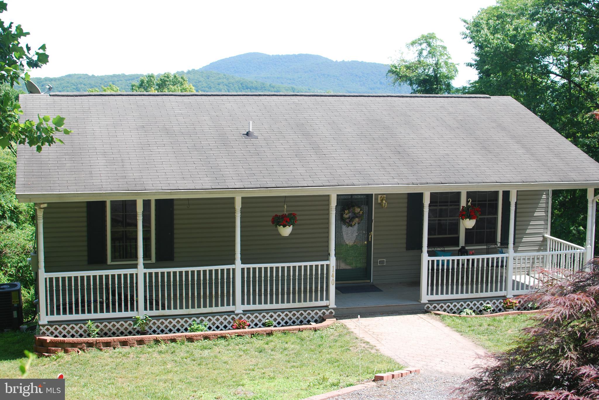 140 Arrowood Road Linden, VA 22642 - Photo 42 of 49 a side view of a house with a small yard and a large window
