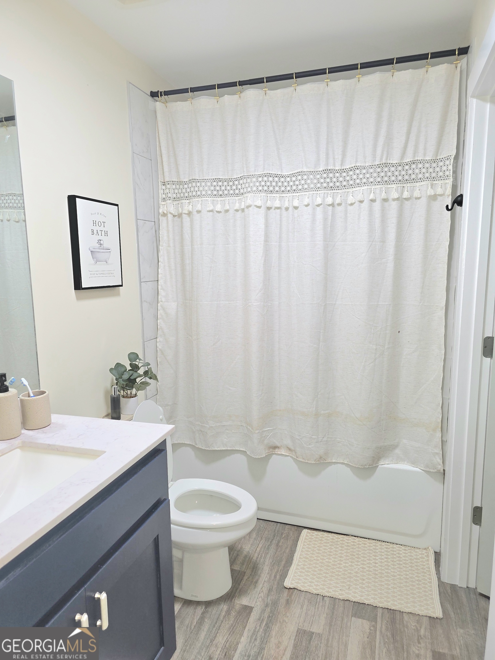 3060 Eatonton Road Madison, GA 30650 - Photo 50 of 65 a bathroom with a sink a toilet and shower