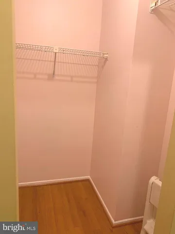 a living room with furniture and a flat screen tv with kitchen view