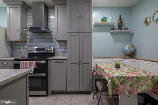 a living room with furniture and a painting on the wall