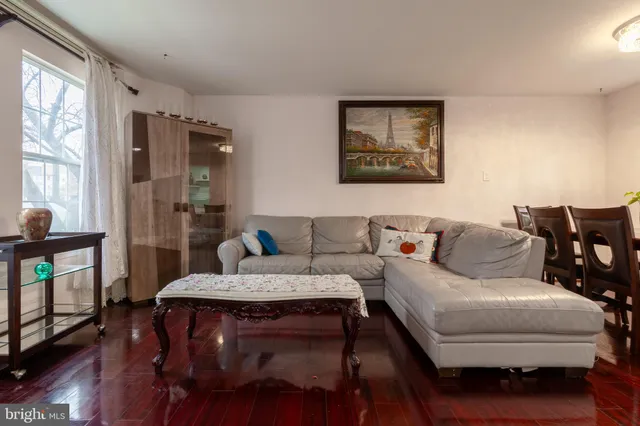 a living room with furniture wooden floor and a flat screen tv