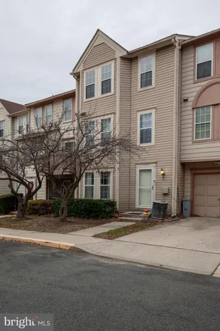 a spacious bathroom with a granite countertop sink a toilet and a mirror