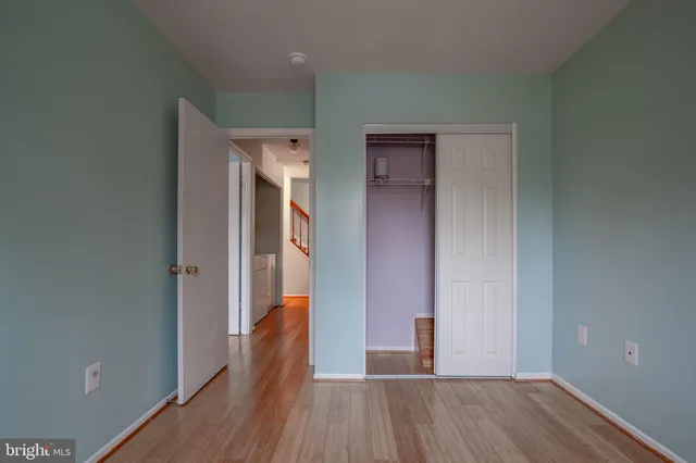 a bedroom with a bed dresser and a ceiling fan