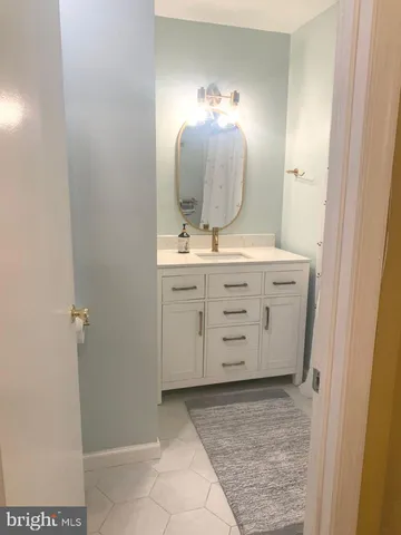 a white toilet sitting next to a sink