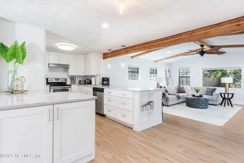 a kitchen with white cabinets and white appliances