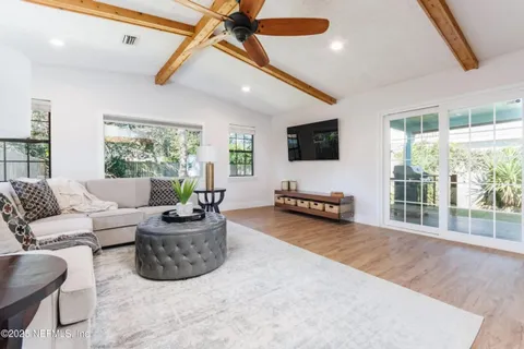 a kitchen with granite countertop white cabinets and stainless steel appliances