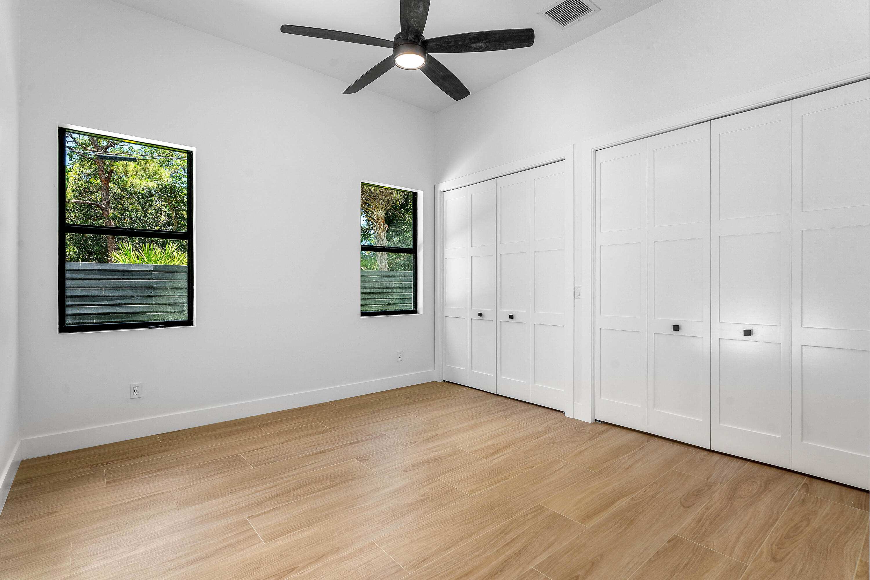5701 Old Orange Road Jupiter, FL 33458 - Photo 28 of 46 a view of an empty room with wooden floor and a window