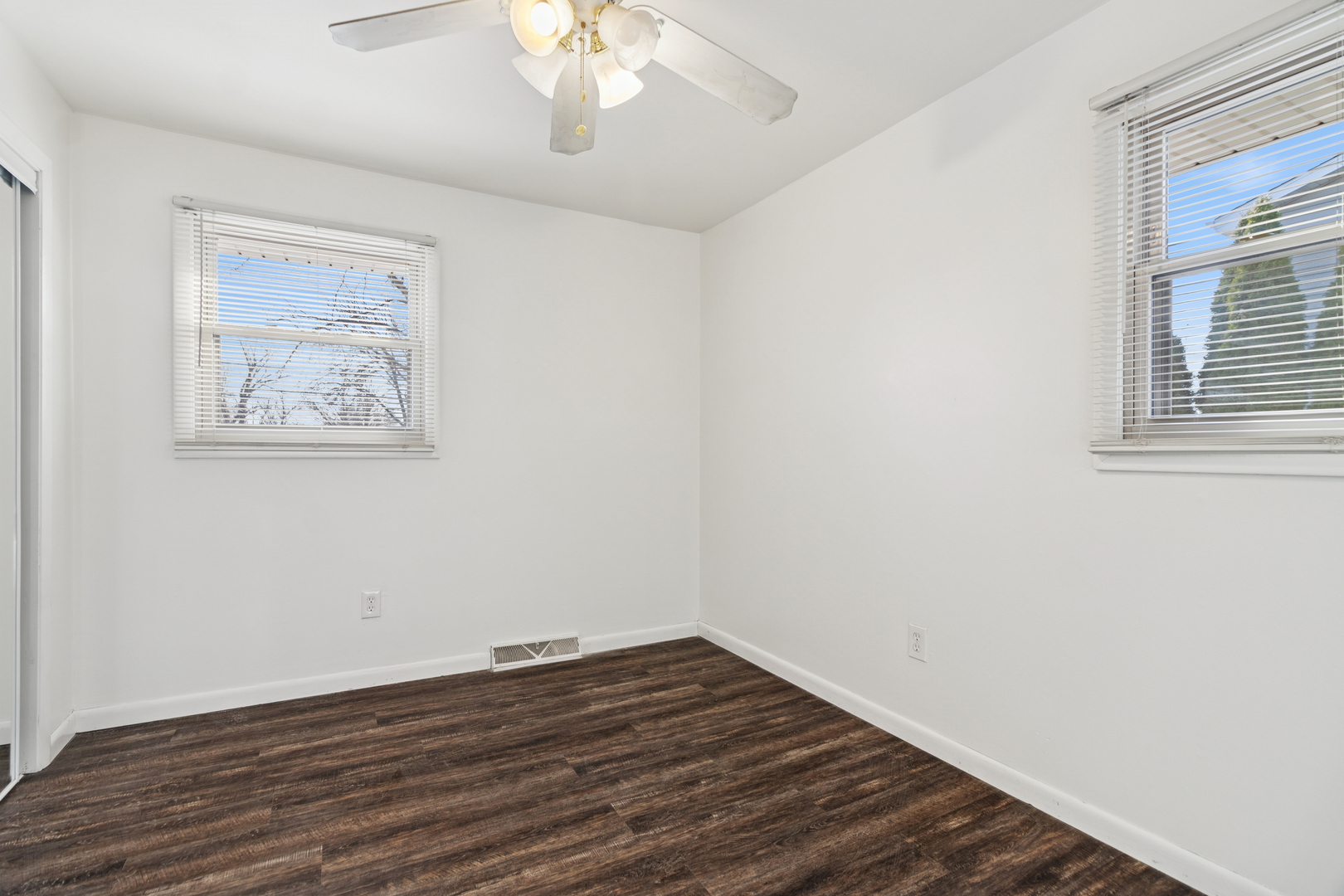 2420 Pecan Street Joliet, IL 60435 - Photo 13 of 20 a view of an empty room with wooden floor and a window