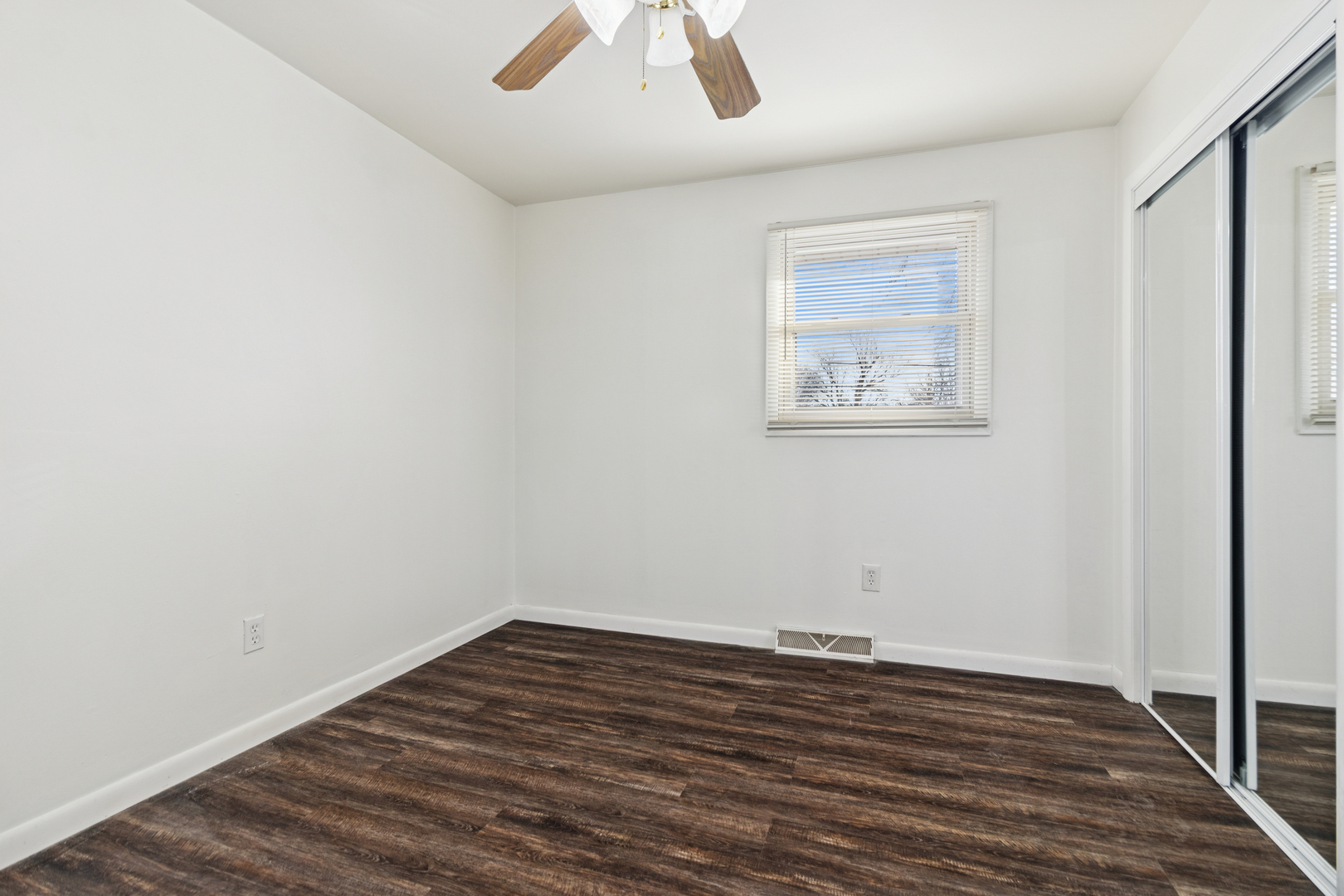 2420 Pecan Street Joliet, IL 60435 - Photo 15 of 20 an empty room with wooden floor and windows