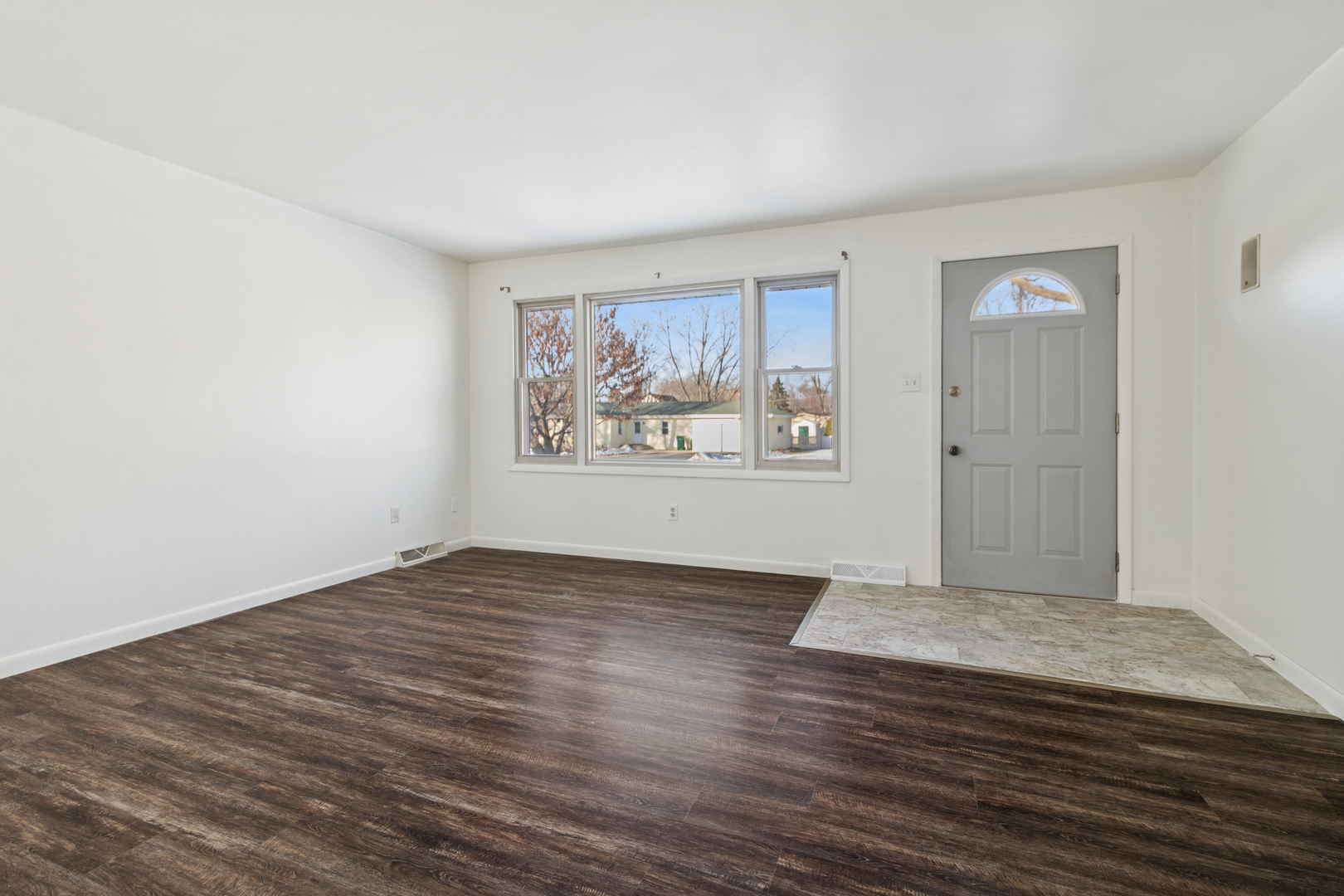 2420 Pecan Street Joliet, IL 60435 - Photo 6 of 20 a view of an empty room with wooden floor and a window