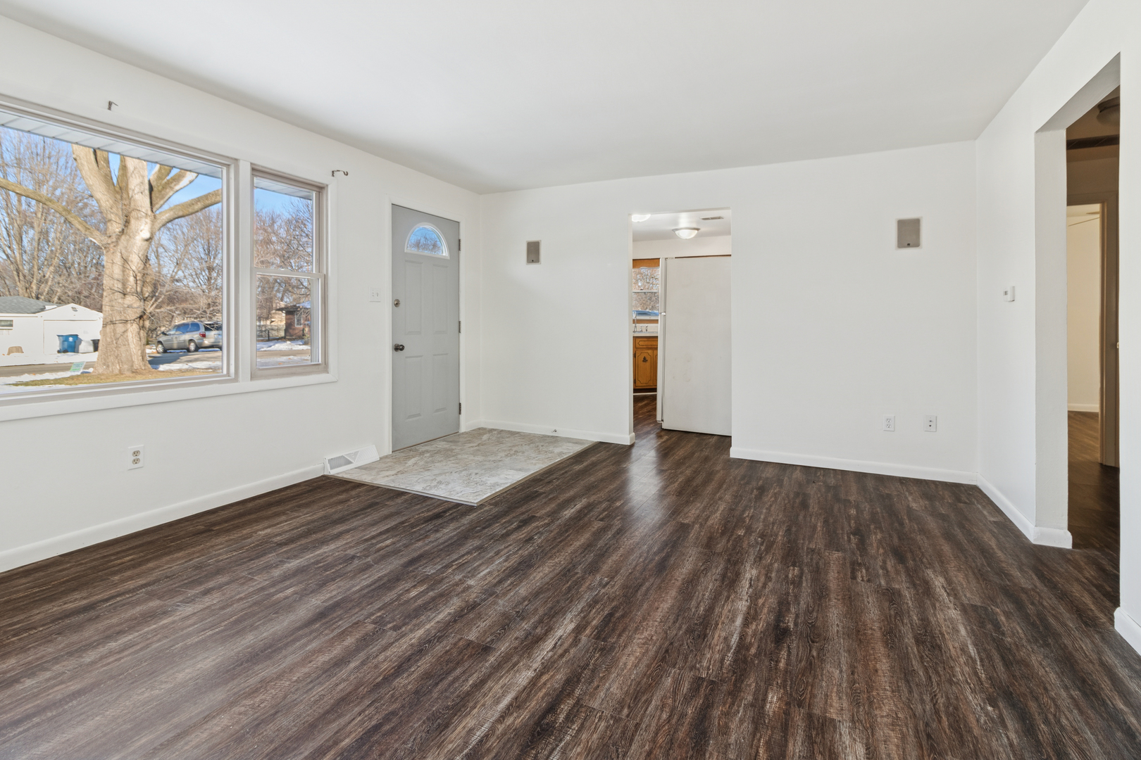 2420 Pecan Street Joliet, IL 60435 - Photo 7 of 20 an empty room with wooden floor and windows