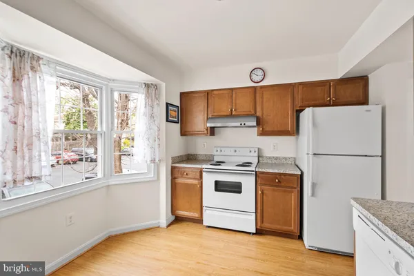 a kitchen with a white cabinets and white appliances